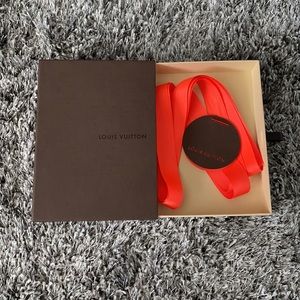 Louis Vuitton box w/ orange ribbon and tag.